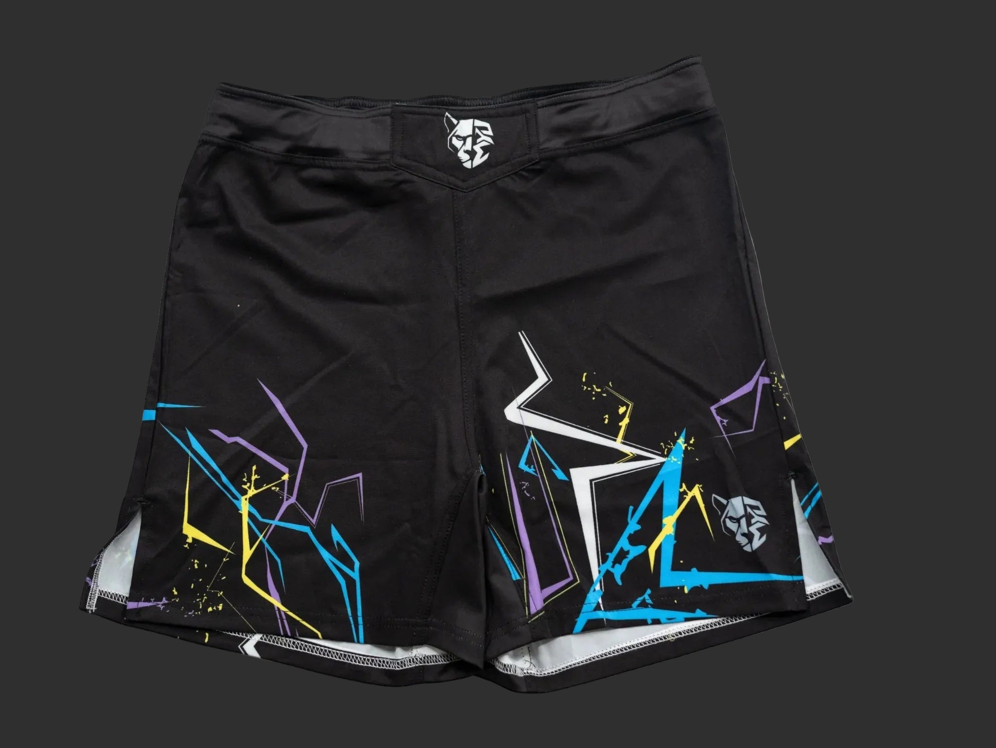 Black athletic shorts with colorful abstract designs on a white background