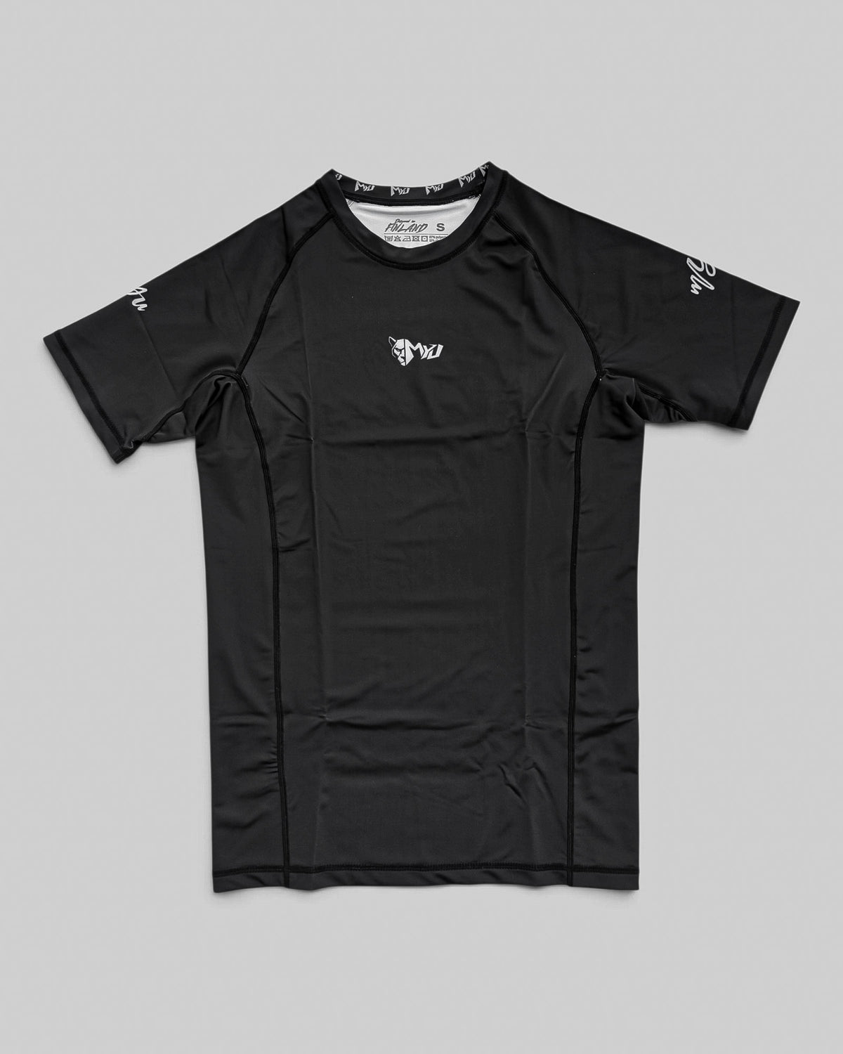 MYU Black rashguard, plain black short-sleeve no-gi BJJ compression top — front view