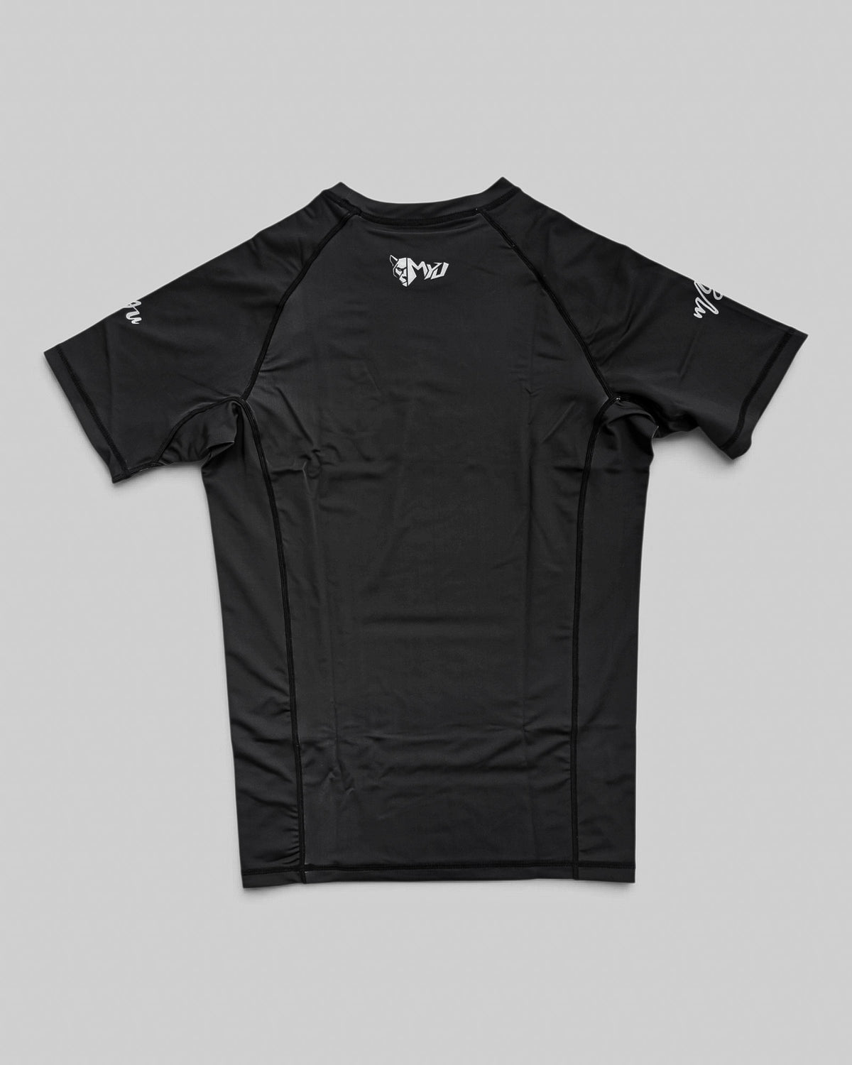 MYU Black rashguard, plain black short-sleeve no-gi BJJ compression top — back view
