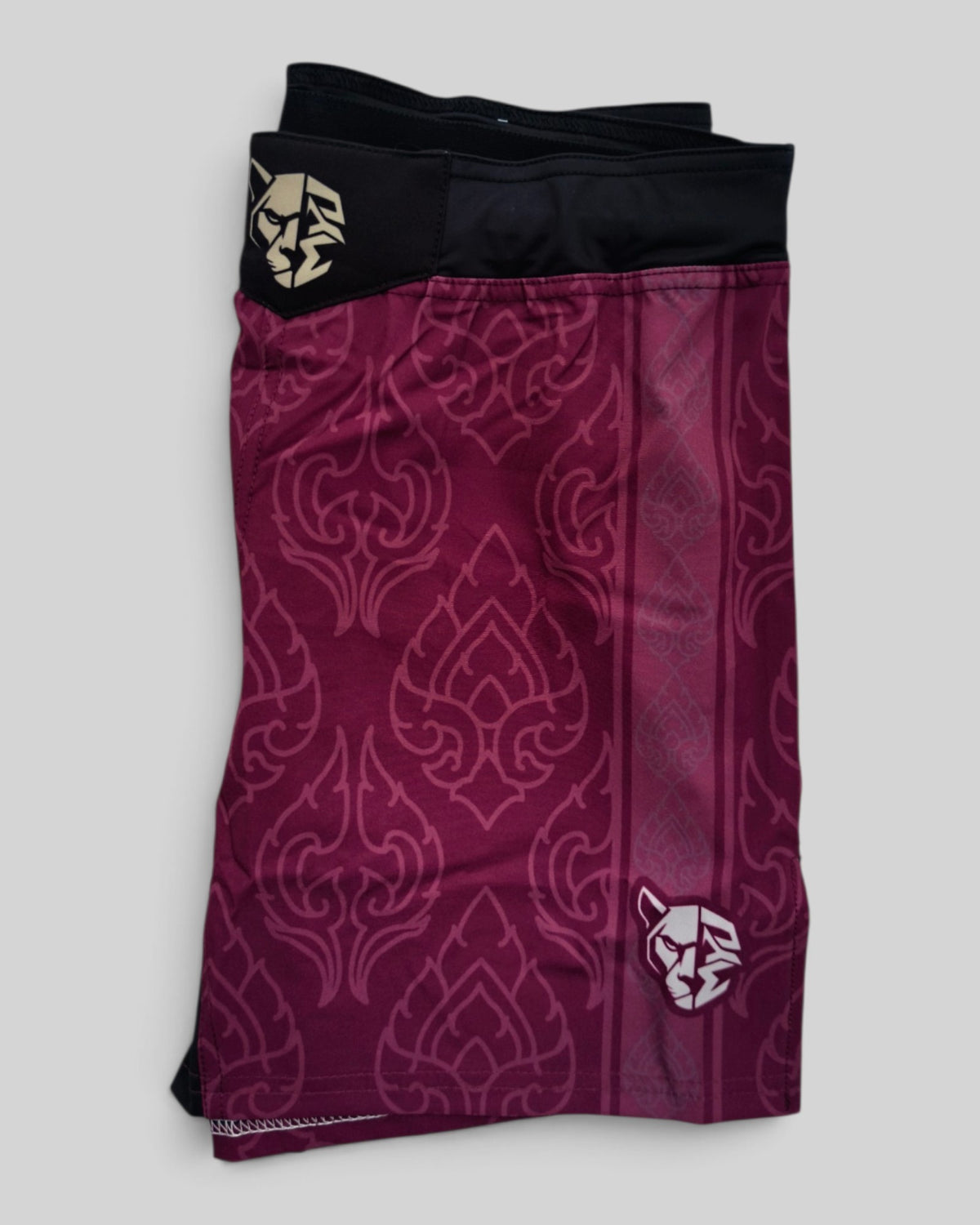 MYU Crimson Ornamental fight shorts, crimson grappling and MMA shorts with ornamental pattern — folded side angle