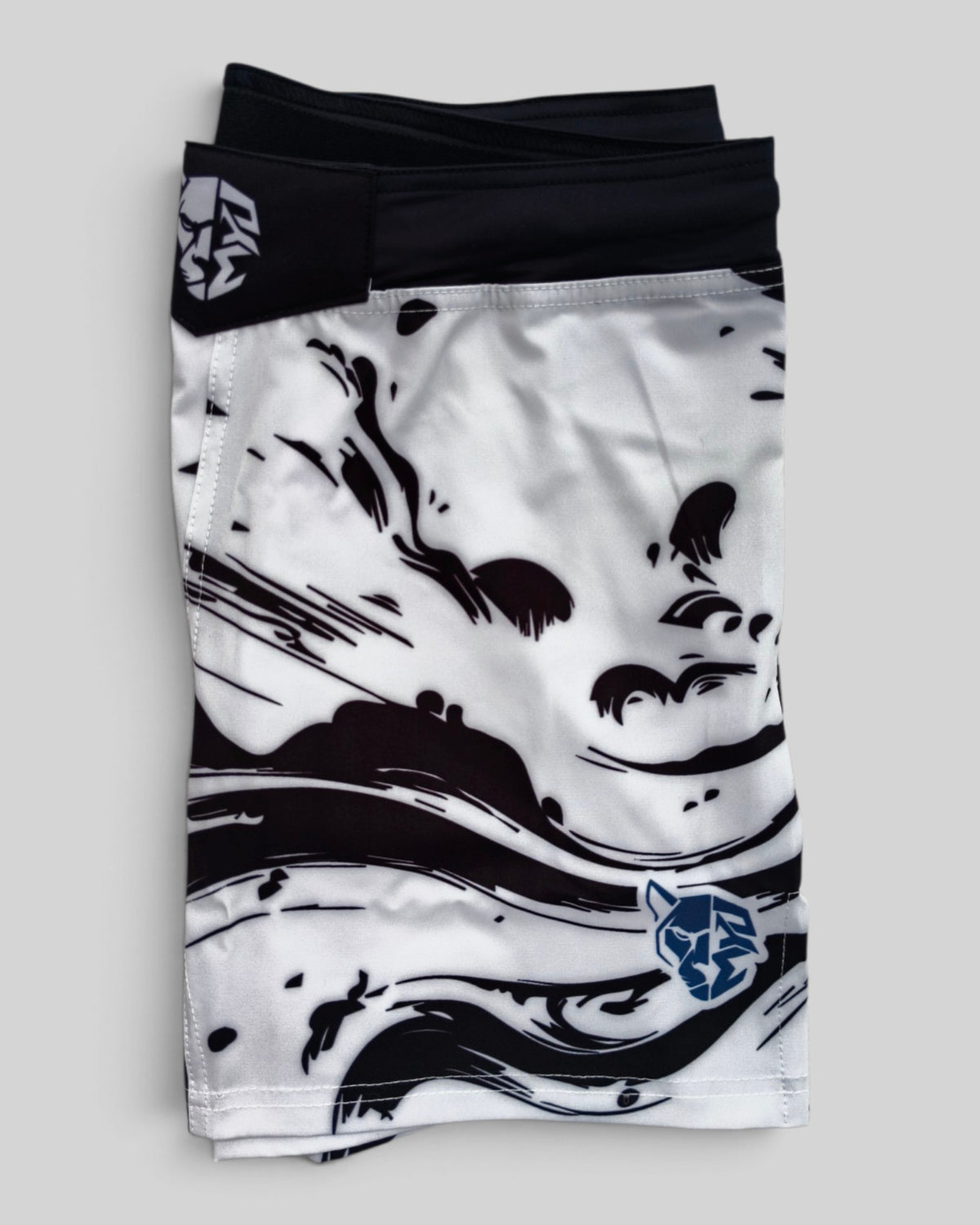 MYU Ink Explosion fight shorts, grappling and MMA shorts with ink splatter print — folded side angle