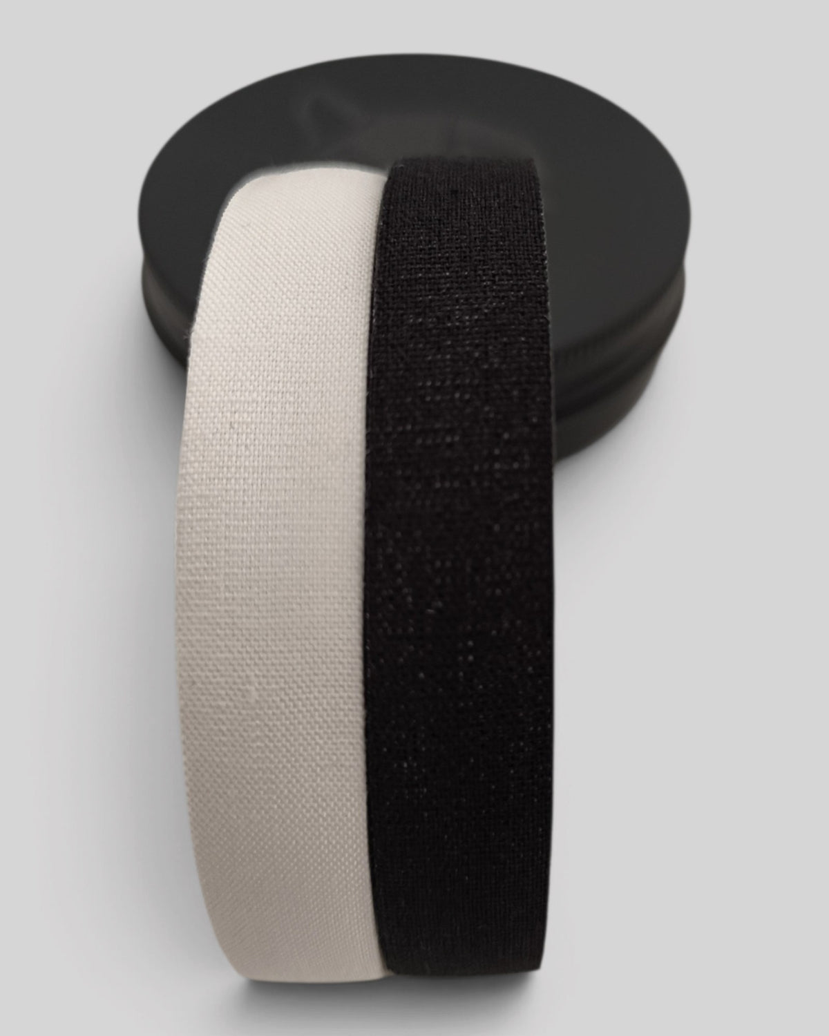 MYU finger tape rolls in a tin box, for BJJ and climbing grip support — close-up detail